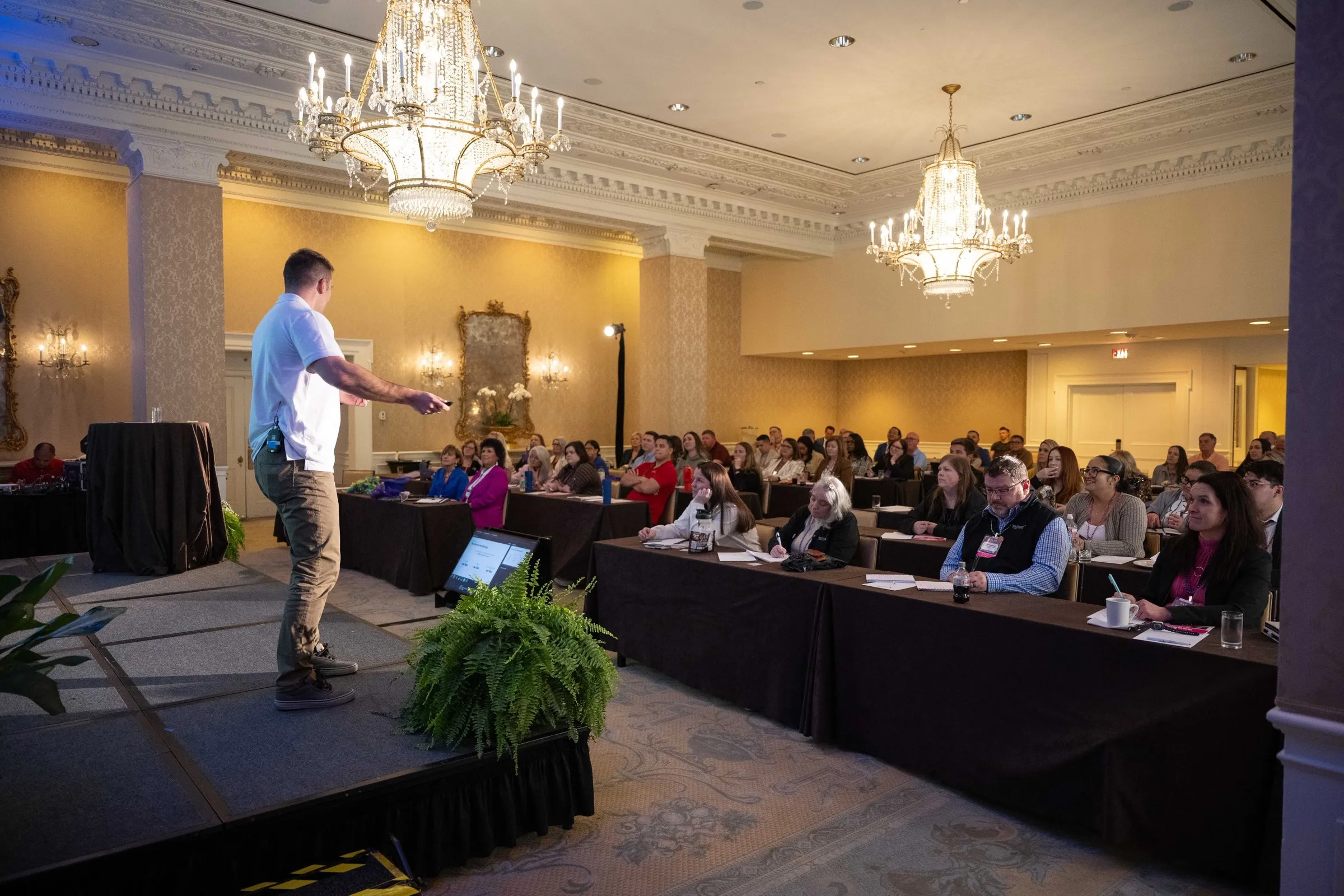 Chris speaking to a full conference room
